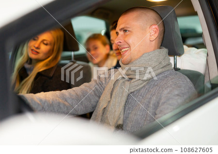 Family having fun and smiling while driving in the car Family having fun and smiling while driving in the car 108627605