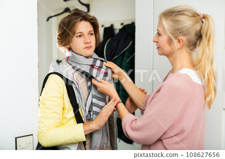 Caring mother send teenager son to school Caring mother send teenager son to school 108627656