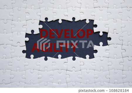 Develop agility symbol. Concept word Develop agility on white puzzle. Beautiful dark blue background. Business and Develop agility concept. Copy space 108628184
