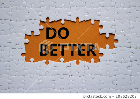 Do better symbol. White puzzle with words Do better. Beautiful orange background. Business and Do better concept. Copy space. 108628202