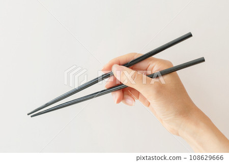 Hand with chopsticks Hand with chopsticks 108629666