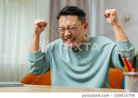 Aggressive Asian man screams stress tension problems panic hopelessness fear surprise shock nervous 108633799