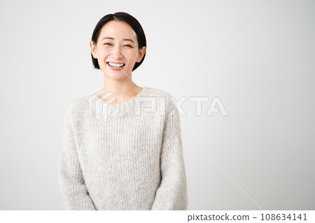 Young woman wearing knitwear lifestyle image Young woman wearing knitwear lifestyle image 108634141