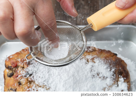 Stollen - sprinkle with powdered sugar Stollen - sprinkle with powdered sugar 108634623