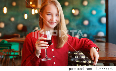 A woman holding a glass of wine A woman holding a glass of wine 108635570