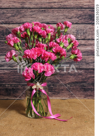 Dark Pink Carnations In Vase With Pink Ribbon and Jeweled Bee Dark Pink Carnations In Vase With Pink Ribbon and Jeweled Bee 108636059