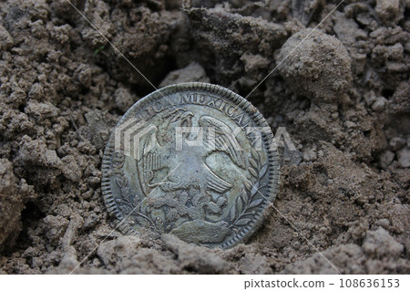 1843 Mexican Libertad Silver Coin on Ground in Dirt Back View 108636153