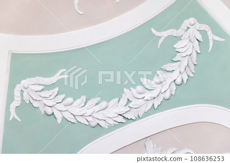 White gypsum bas-relief over light green background, ceiling design White gypsum bas-relief over light green background, ceiling design 108636253