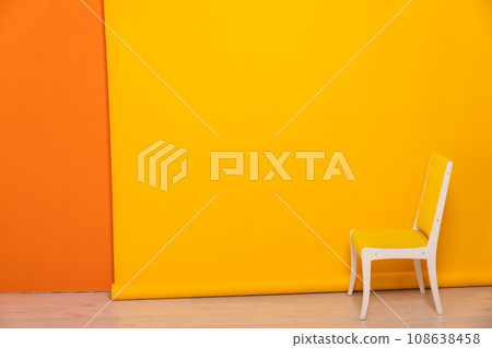 Yellow vintage chair in interior on orage background 108638458