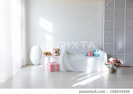 Interior of a white room with a sofa with flowers 108638486
