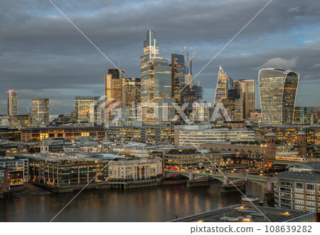 The skyscrapers in the business district of London with the River Thames at sunset. The skyscrapers in the business district of London with the River Thames at sunset. 108639282