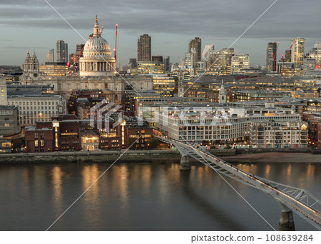 Thames River, With St. Paul's Cathedral Rising Above All the Other Buildings with Millennium Bridge at dusk. Thames River, With St. Paul's Cathedral Rising Above All the Other Buildings with Millennium Bridge at dusk. 108639284