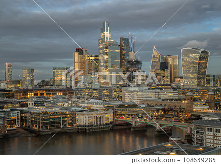 The skyscrapers in the business district of London with the River Thames at sunset. The skyscrapers in the business district of London with the River Thames at sunset. 108639285
