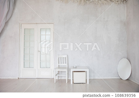 White Chair Coffee Table And Oval Mirror In Empty White Room Interior 108639356