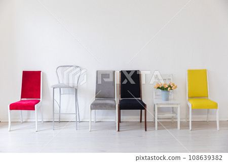 Lots of different chairs in the interior of a white room 108639382