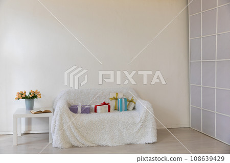 Interior of a white room with a sofa with flowers Interior of a white room with a sofa with flowers 108639429