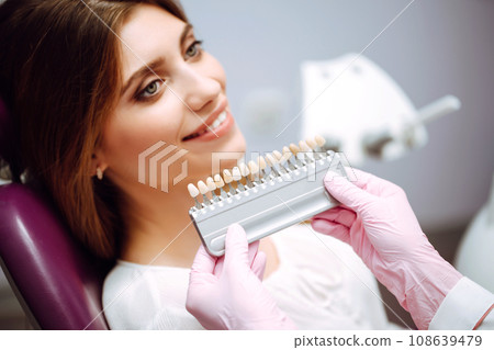 Beautiful woman smile with healthy teeth whitening. Matching shades of the implants. Healthy Smile. Beautiful woman smile with healthy teeth whitening. Matching shades of the implants. Healthy Smile. 108639479