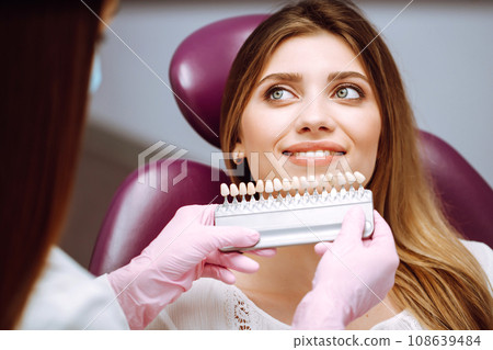 Beautiful woman smile with healthy teeth whitening. Matching shades of the implants. Healthy Smile. 108639484