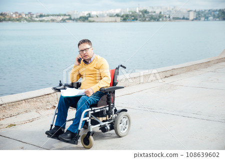 a man on a walk by the sea talking on the phone a man on a walk by the sea talking on the phone 108639602