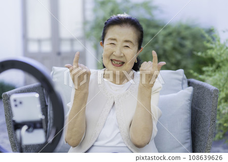 Senior woman doing Instagram live Senior woman doing Instagram live 108639626