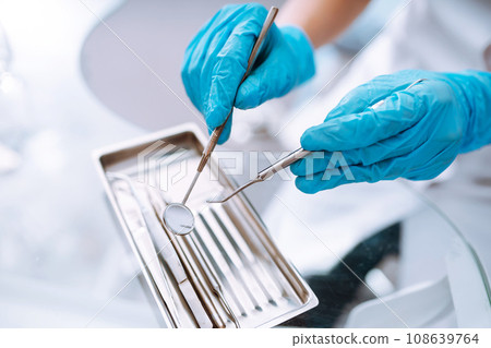 A set of sterile dental instruments for dental treatment. Dental care for people. A set of sterile dental instruments for dental treatment. Dental care for people. 108639764