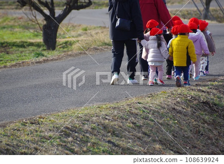 A group of nursery school children taking a walk in the cold winter 108639924