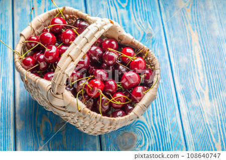 Fresh cherries in a wicker basket. Fresh cherries in a wicker basket. 108640747