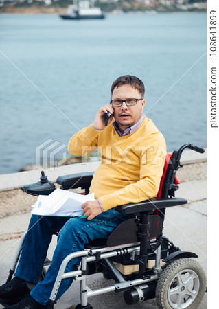 A man with a mobile phone by the sea 108641899