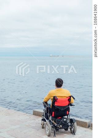 A man with disabilities breathes sea air by the sea 108641900