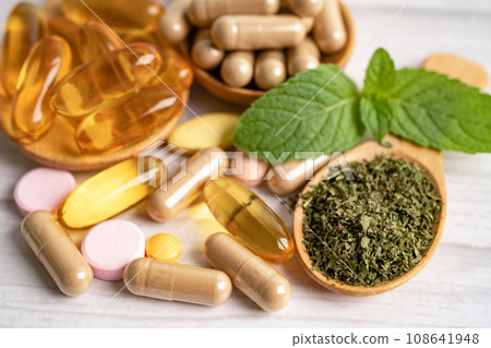 Alternative medicine herbal organic capsule with vitamin E omega 3 fish oil, mineral, drug with herbs leaf natural supplements for healthy good life. Alternative medicine herbal organic capsule with vitamin E omega 3 fish oil, mineral, drug with herbs leaf natural supplements for healthy good life. 108641948