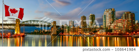 Canadian flag in front of Ferry boat docked along in Granville island near Burrard Street Bridge at twilight in Vancouver,Canada 108641984