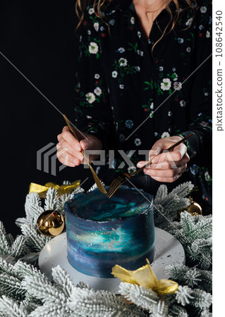 a woman cuts a cake for a holiday pastry chef a woman cuts a cake for a holiday pastry chef 108642540