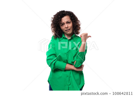 young brunette leader woman dressed in a green blouse points her hand to the side young brunette leader woman dressed in a green blouse points her hand to the side 108642811