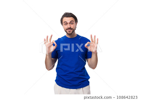young handsome european man with black hair and beard dressed in a blue t-shirt young handsome european man with black hair and beard dressed in a blue t-shirt 108642823