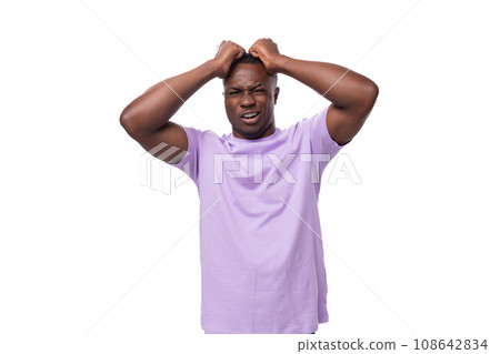 portrait of a young excited american man in a lilac t-shirt upset and worried about something portrait of a young excited american man in a lilac t-shirt upset and worried about something 108642834