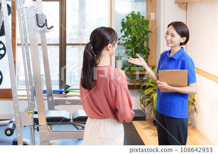 Staff and customers providing information on joining a sports gym Staff and customers providing information on joining a sports gym 108642933