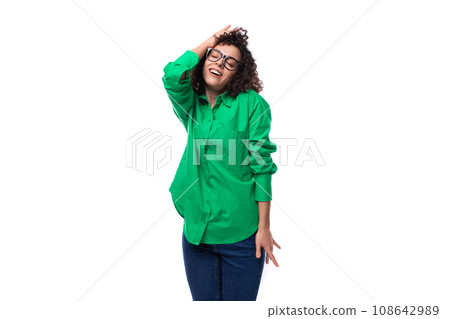 positive beautiful young business woman dressed in a green shirt is dancing 108642989