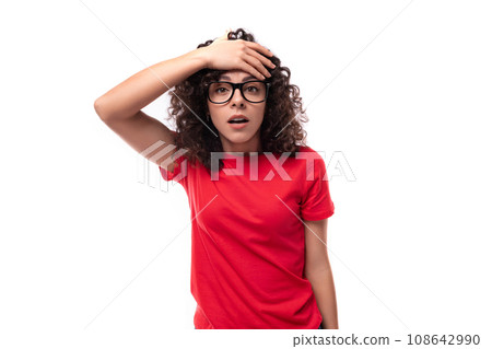 young excited curly brunette woman dressed in a red basic t-shirt 108642990