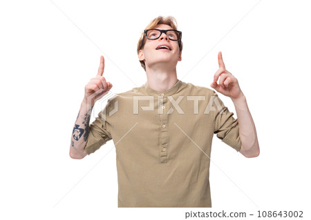 handsome young caucasian male promoter with red hair and a tattoo on his arm dressed in a khaki handsome young caucasian male promoter with red hair and a tattoo on his arm dressed in a khaki 108643002