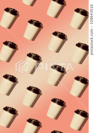 Coffee to go regular pattern made of photo on coral pink gradient background. Paper cups with black lids.Trendy flat lay 108643016