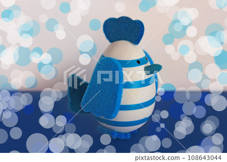 Easter holiday card with cute blue and white egg Chick toy with felt wings, tail and tuft.Trendy color of 2020 year. Easter holiday card with cute blue and white egg Chick toy with felt wings, tail and tuft.Trendy color of 2020 year. 108643044