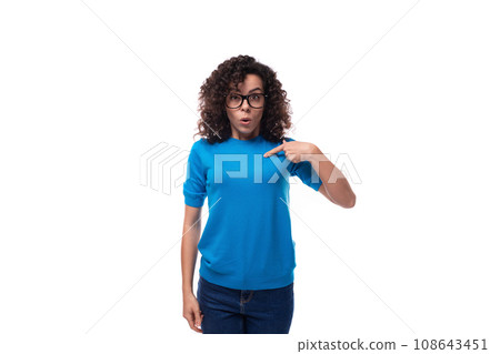 young slender curly woman with black hair is dressed in a blue t-shirt with an identity mockup 108643451