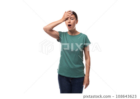 a young woman with black hair and a slim figure dressed in a green T-shirt is tired and angry a young woman with black hair and a slim figure dressed in a green T-shirt is tired and angry 108643623
