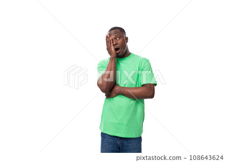 young smart american male advertiser dressed in green t-shirt with mockup thoughtful young smart american male advertiser dressed in green t-shirt with mockup thoughtful 108643624