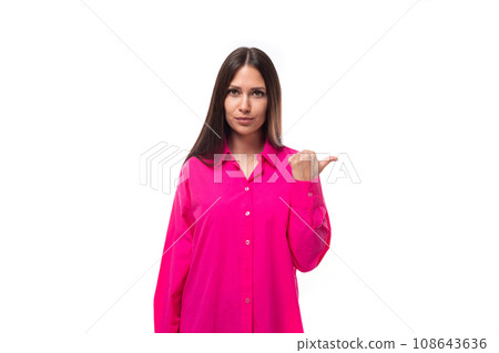 portrait of a european young lady with black hair in a crimson shirt pointing her finger to the side portrait of a european young lady with black hair in a crimson shirt pointing her finger to the side 108643636