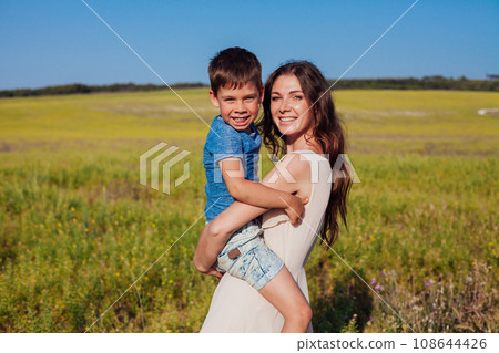mother and son family on a walk in the field travel walk 108644426