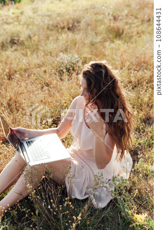 Woman with laptop working in nature travel freelance online Woman with laptop working in nature travel freelance online 108644431