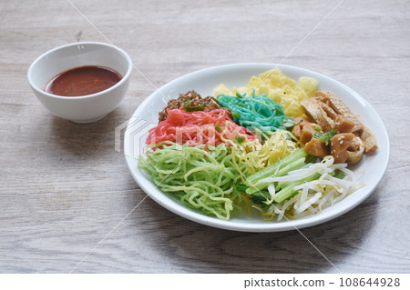 colorful noodles with sausage and fish line couple bean sprout on plate dressing spicy Korean sauce  108644928