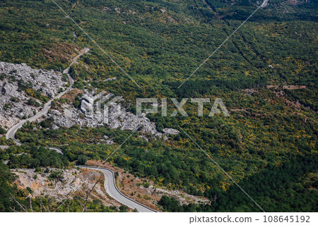 mountainous terrain rocks view from above in nature green forest below mountainous terrain rocks view from above in nature green forest below 108645192
