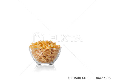 Pasta products in the form of a spiral on a plate, texture, on a white background Pasta products in the form of a spiral on a plate, texture, on a white background 108646220